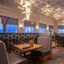 Sandman Signature Ottawa Airport Hotel in Ottawa restaurant with booths, wooden tables and city view windows