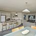 Pavilion Beachfront Apartments in Mount Maunganui, open-plan apartment with kitchen, dining area and lounge
