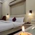 The Rass, Kanpur hotel room with double bed, bedside lamps and city view window
