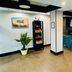 Quality Inn Danville - University Area lobby with seating area, TV wall, and potted plant in Danville