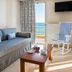 Georgalas Sun Beach Resort room with sofa, balcony sea view, and rocking chair in Nea Kallikratia