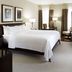 The Barrington Hotel in Halifax guest room with king bed, desk, armchair and floor-to-ceiling windows