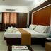Sai Sangam Hotel, Shirdi guest room with double bed, TV, and window drapes