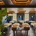 Seda Club Hotel in Granada dining room with tables, banquettes, and large windows