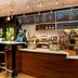 Courtyard by Marriott Dallas Lewisville bar and café counter with stools, menu boards, and beverage displays