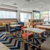 Hampton Inn Sarasota-I-75 Bee Ridge breakfast area with tables, chairs, and large windows in Sarasota