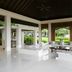 Open-air lounge at The Ungasan Clifftop Resort in South Kuta with white seating and garden views