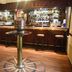 Tongadale Hotel in Portree bar with wooden counter, bar stools and bottle display