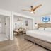Hotel Cabana Clearwater Beach room with king bed, seating area, ceiling fan and kitchenette in Clearwater Beach