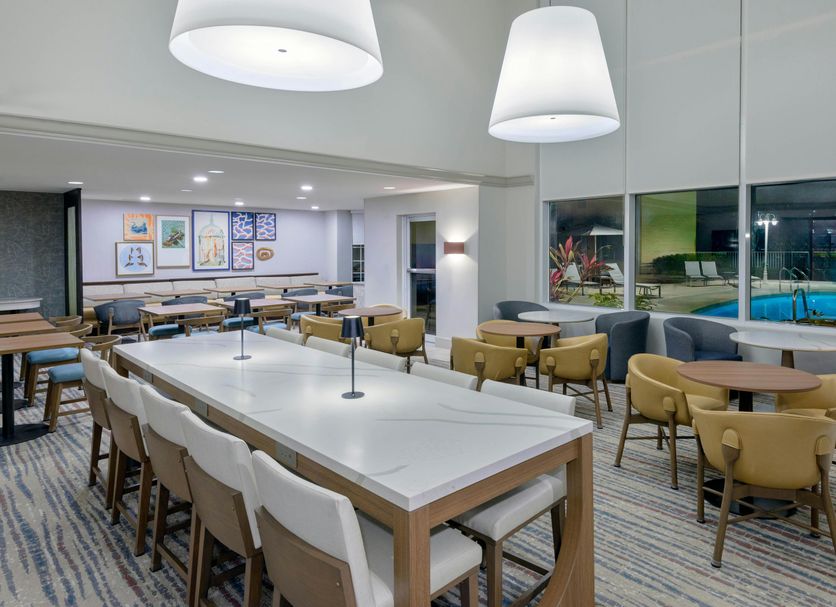 Homewood Suites by Hilton Bonita Springs Naples North lounge with seating and pool view