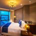 Vip Hotel Doha guest room with king bed, floor-to-ceiling window, and city view