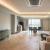 The Path Siam Bangkok suite with seating area, dining table and city-view windows