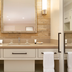 Silverado Resort Napa bathroom vanity with double sinks, large mirror and neutral stone tile
