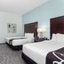 La Quinta Inn & Suites by Wyndham Bonita Springs Naples N. guest room with two beds and TV