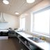 Danhostel Frederikshavn City kitchen with stove, sink, counter space, and large windows in Frederikshavn