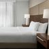 Residence Inn by Marriott Santa Clarita Valencia guest room with king bed, TV, and window drapes
