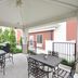 Candlewood Suites Cape Girardeau patio with tables, chairs, and grill under a covered pergola