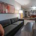 Candlewood Suites Baytown By IHG living room with sofa, chair, coffee table and kitchenette