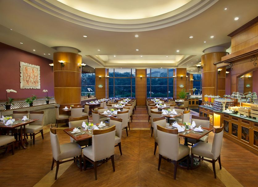 Millennium Hotel Sirih Jakarta in Jakarta restaurant with set dining tables and large windows
