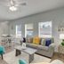 Seashell Village Resort Port Aransas living room with sofa, armchair, dining table and kitchen area