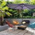 Outdoor courtyard lounge at ibis Paris Alésia Montparnasse 14ème in Paris with colorful chairs and umbrella