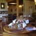 Sans Souci Inn in Pohara dining room with round wooden tables and set place settings