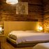 Home++ Xi'an in Xi'an: rustic wood-paneled guest room with two beds and warm bedside lamps
