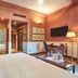 Hotel de la Ville Monza guest room with canopy bed, writing desk, wardrobe and TV in Monza