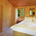 Arcadia Hotel in Cirali: wood-paneled bedroom with a double bed and garden-facing windows