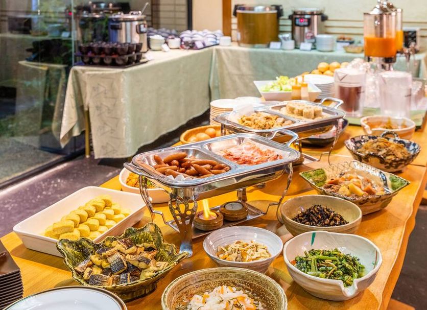 Plaza Hotel Toyota buffet table with assorted breakfast dishes and drinks in Toyota