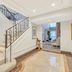Indian Wells Resort Hotel lobby with staircase, tiled floor, and seating area in Indian Wells