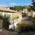 Les Lauriers in Saint-Tropez with tiled rooftops, lush trees, and a sunny village view