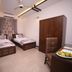 Zifan Hotel & Suites in Karachi twin room with two single beds, wardrobe, and desk