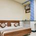 New Royal Hotel in New Delhi guest room with bed, desk, wall AC and window