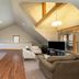 Franziska Haus Dundee guest room with vaulted ceiling, sitting area, TV and twin windows
