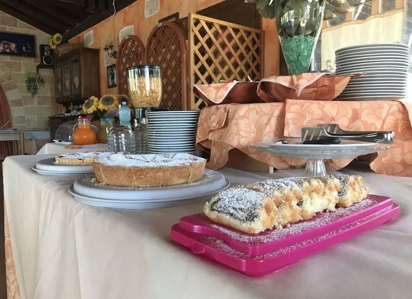Agriturismo Serafina in Otranto dessert buffet with pastries, tarts and stacked plates