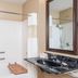 Ramada by Wyndham Strasburg/Shenandoah Valley bathroom with shower, black vanity and mirror in Strasburg