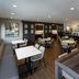 Residence Inn by Marriott Wilkes-Barre Arena dining area with tables, chairs, and a breakfast counter