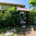 Cabinas Tortuguero Natural in Tortuguero with lush garden path and tropical cabana exterior