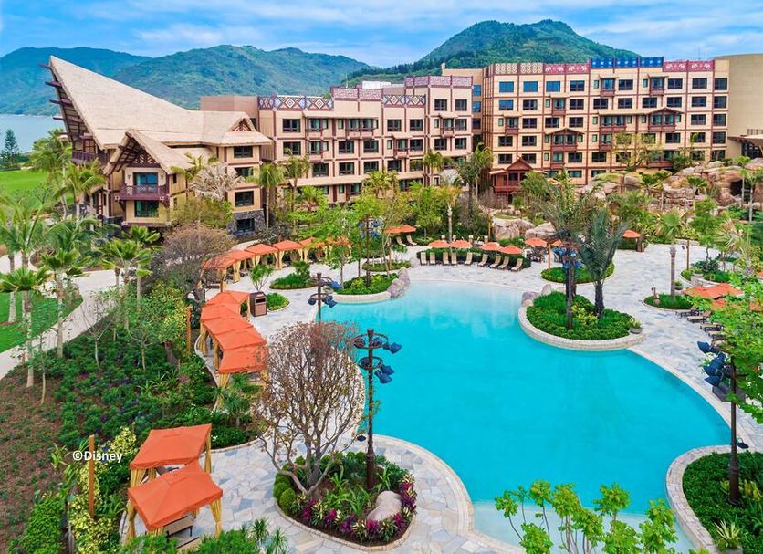 Disney Explorers Lodge in Hong Kong with a lagoon-style pool, landscaped gardens, and mountain backdrop