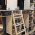 bnbplus Niigata Book Inn in Niigata: bunk beds beside a wall of bookshelves