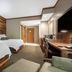 Norfolk Lodge & Suites, Ascend Collection Hotel guest room with two beds and desk in Norfolk