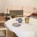 Hotel Vier Jahreszeiten in Volkach: lounge with sofa, armchairs and a round table set with cups