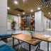 Hotel With Jeju lobby in Jeju City with modern seating, wood tables, and open shelving