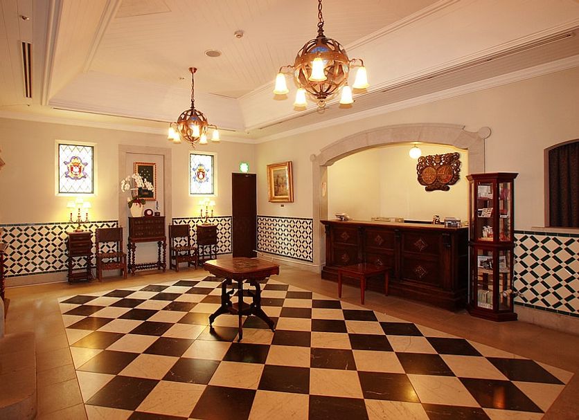 Hotel Monterey Nagasaki lobby with checkered floor, chandeliers, reception desk, and ornate decor in Nagasaki
