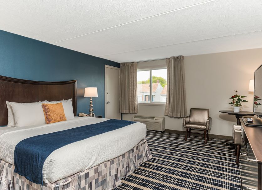 Rockport Inn and Suites guest room with king bed, window view, desk and chair in Rockport