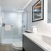 DoubleTree by Hilton New York JFK Airport bathroom in Queens with glass-enclosed shower and vanity