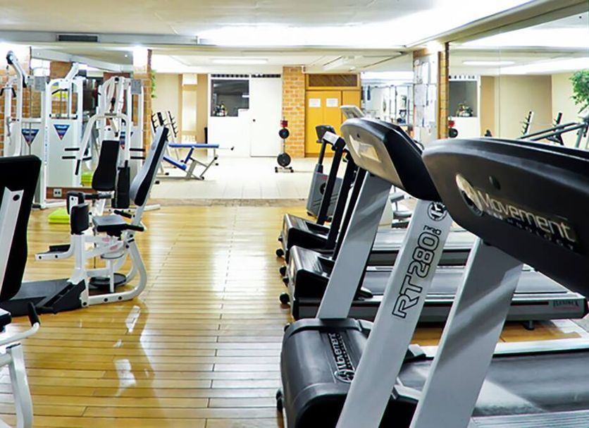 Hotel Embaixador in Porto Alegre gym with treadmills, weight machines and mirrored walls