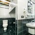 Bathroom at Deniz Inn Boutique Hotel in Baku with glass shower, sink, and toilet