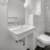7Days B&B Bratislava bathroom with wall-mounted sink, toilet, walk-in shower and tiled floor